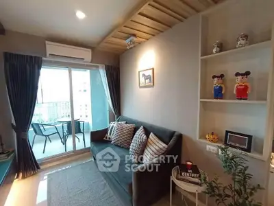 Cozy living room with balcony view, modern decor, and ample natural light.