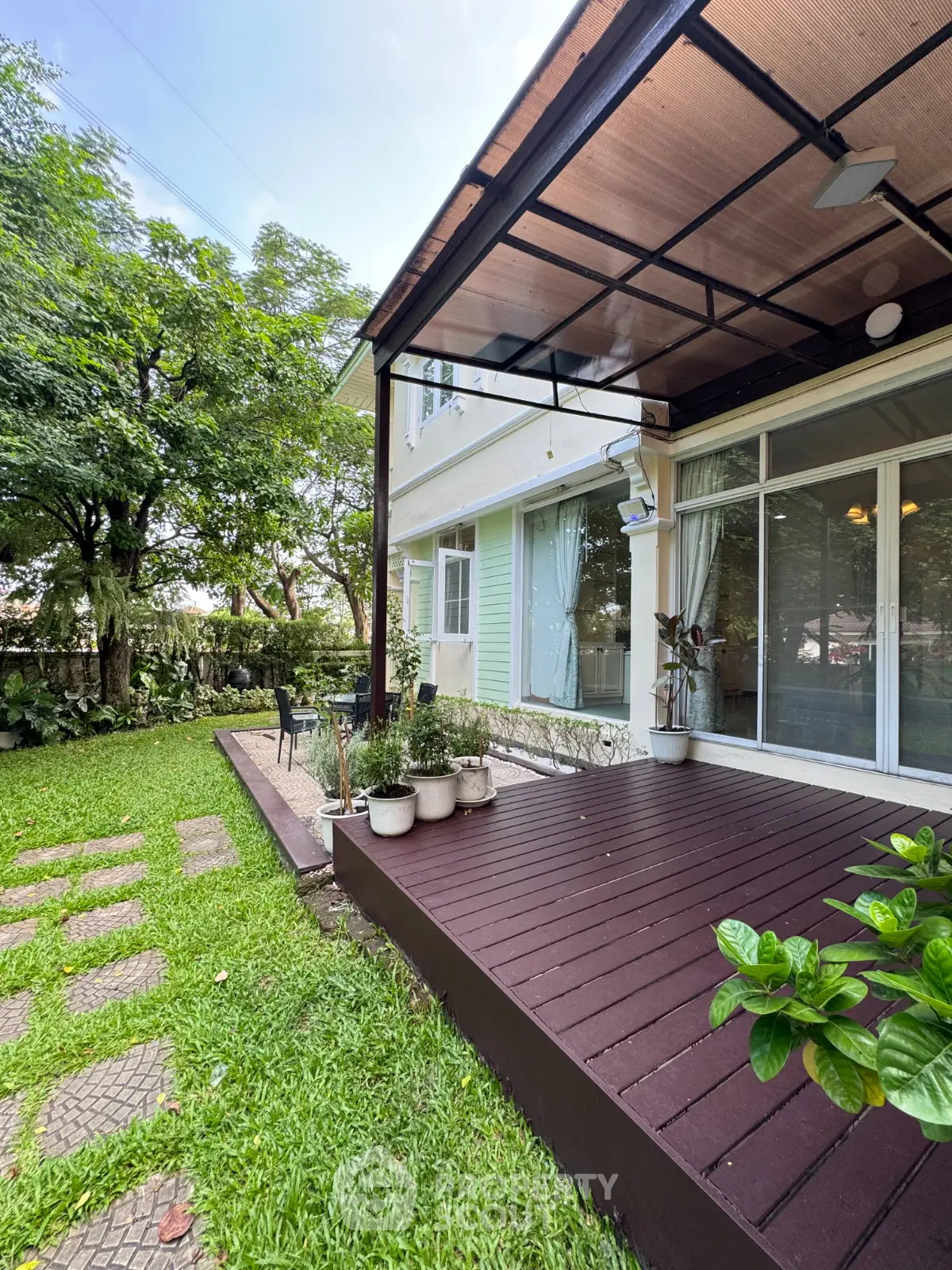Charming garden view with cozy patio and lush greenery, perfect for outdoor relaxation and entertaining.