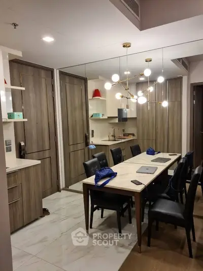 Modern dining area with elegant lighting and wooden accents in a stylish apartment.