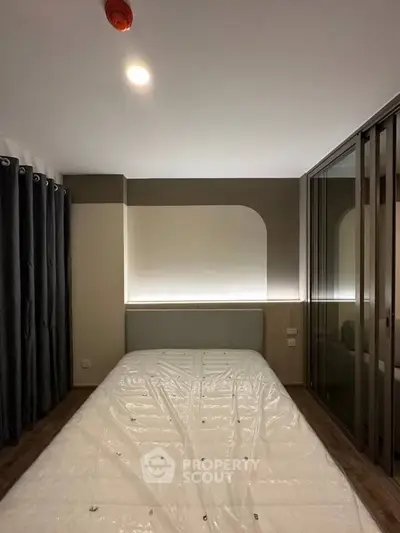 Modern bedroom with sleek design and ambient lighting, featuring a large bed and stylish curtains.