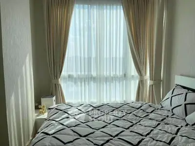 Bright bedroom with large window and elegant curtains