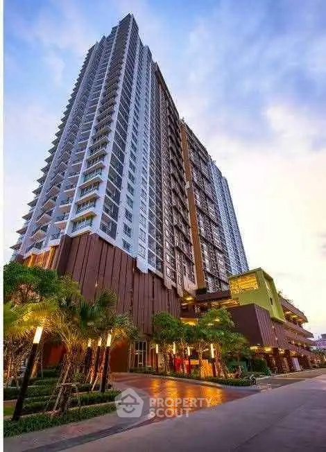 Stunning high-rise condominium with modern architecture and lush landscaping in urban setting.