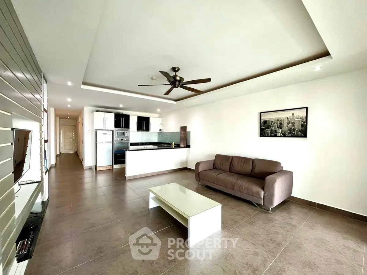 Spacious modern living room with open kitchen and sleek design