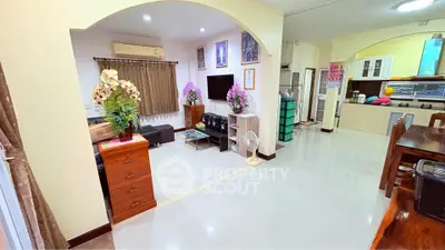 Spacious open-plan living room with modern kitchen and elegant decor
