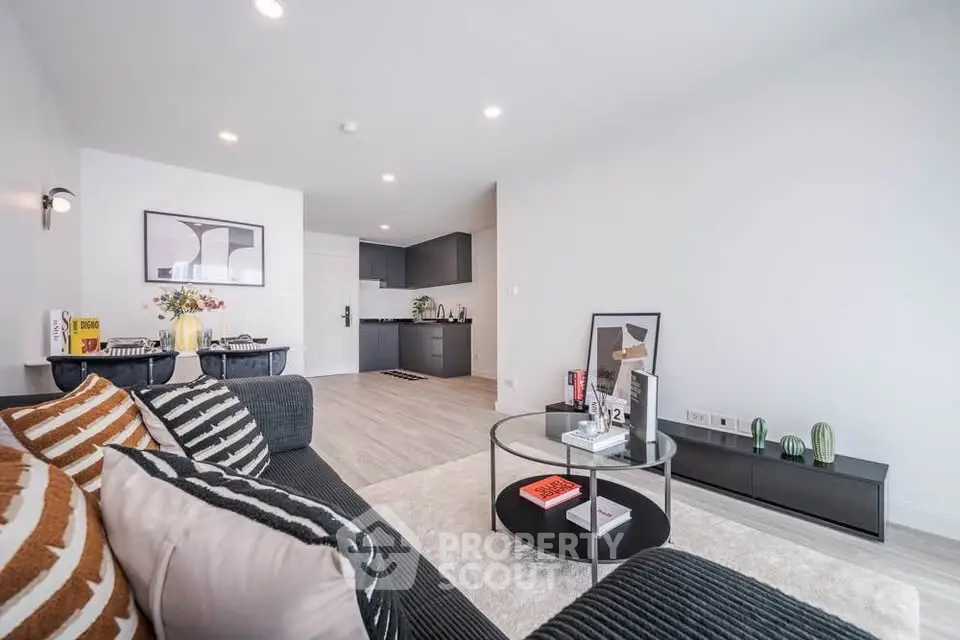 Modern living room with stylish decor and open kitchen layout in a contemporary apartment.
