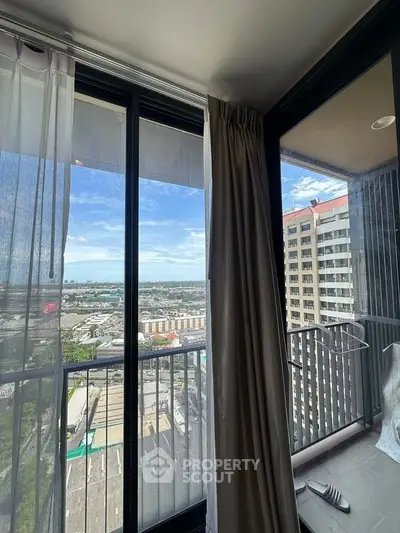 Stunning high-rise balcony view with cityscape and ocean in the background.