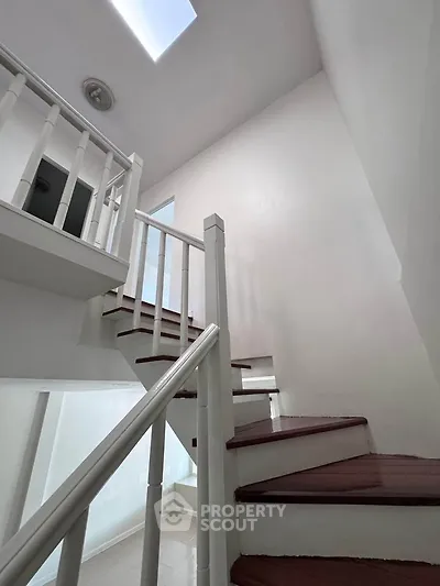 Elegant staircase with skylight in modern home interior