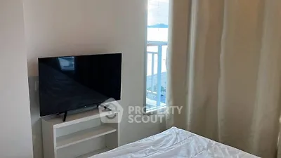 Cozy bedroom with TV and window offering scenic view