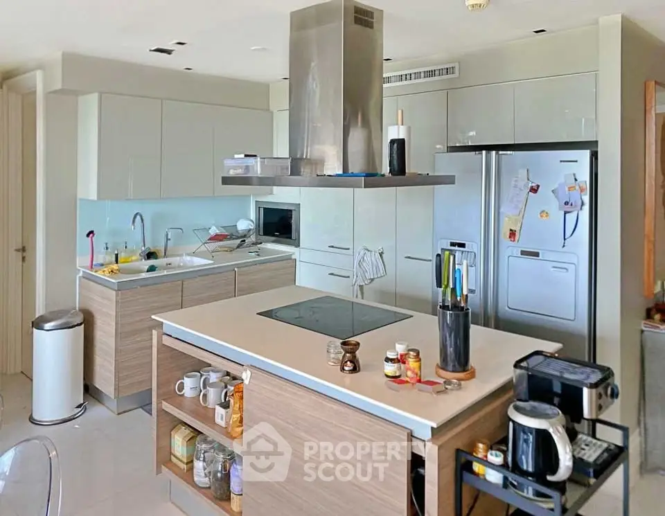 Modern kitchen with sleek cabinetry, island, and stainless steel appliances in a contemporary home.