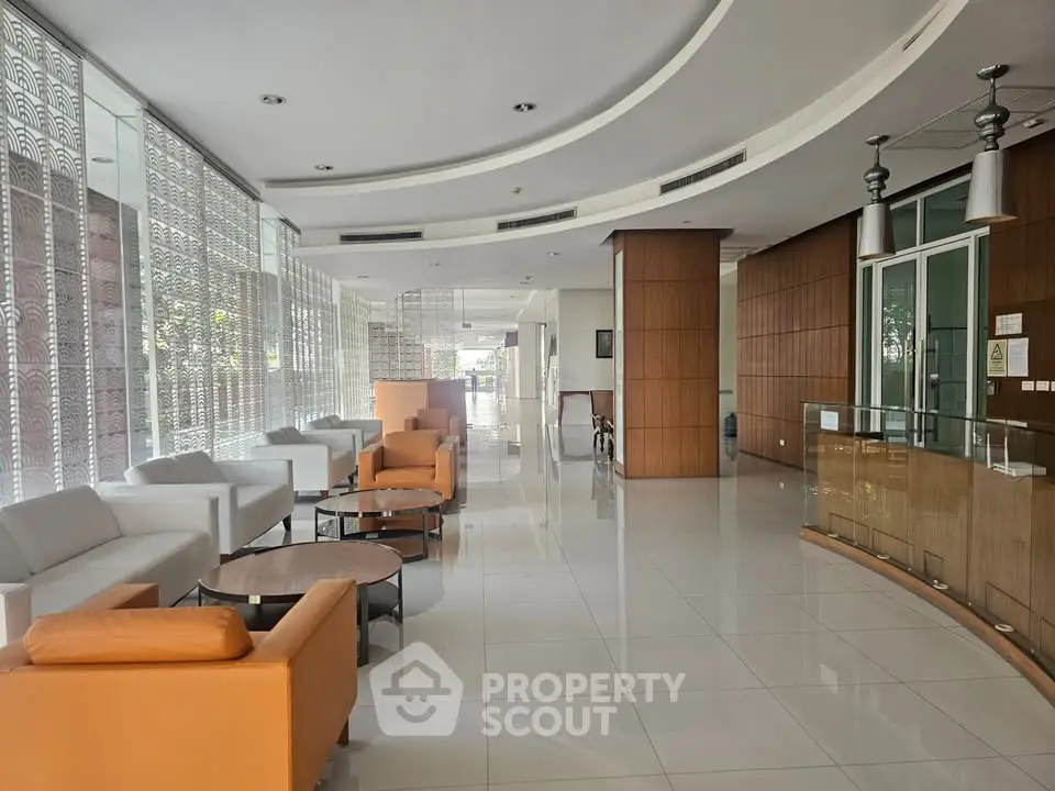 Modern lobby with sleek design and comfortable seating in a contemporary building.