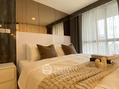 Luxurious bedroom with elegant decor and large windows offering natural light.