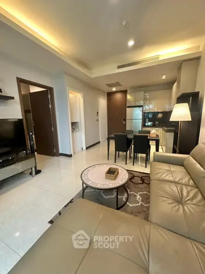 Modern open-plan living room with sleek kitchen and cozy seating area