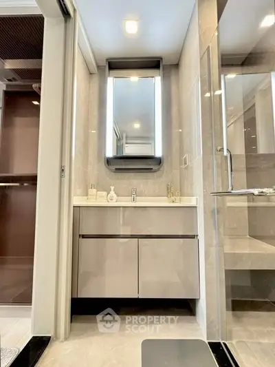 Modern bathroom with sleek vanity and glass shower enclosure
