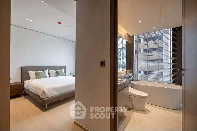 Luxurious modern bedroom and bathroom suite with elegant design and city view.