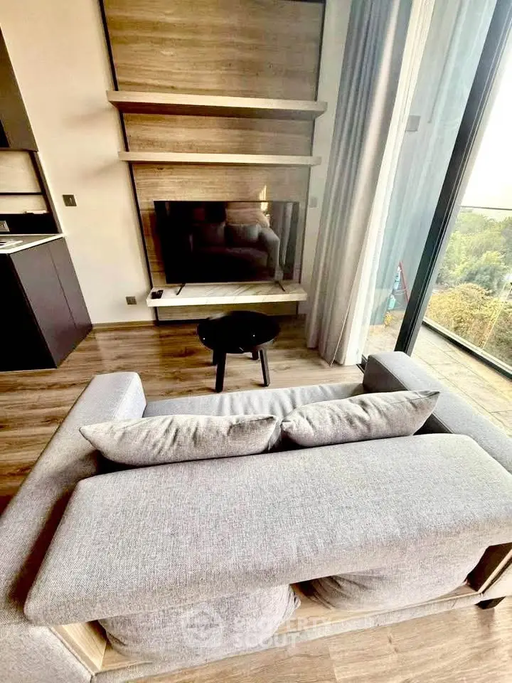 Modern living room with stylish decor and large windows offering scenic views.