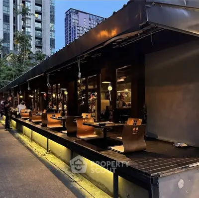 Chic outdoor dining area with modern seating in urban setting, perfect for evening gatherings.