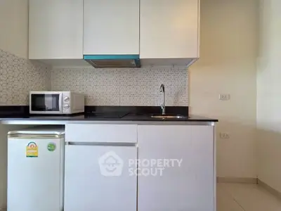 Modern kitchen with sleek cabinetry and compact appliances