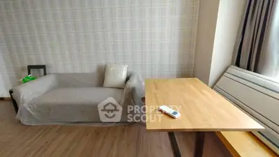 Cozy living room with modern sofa and wooden table, perfect for relaxation.