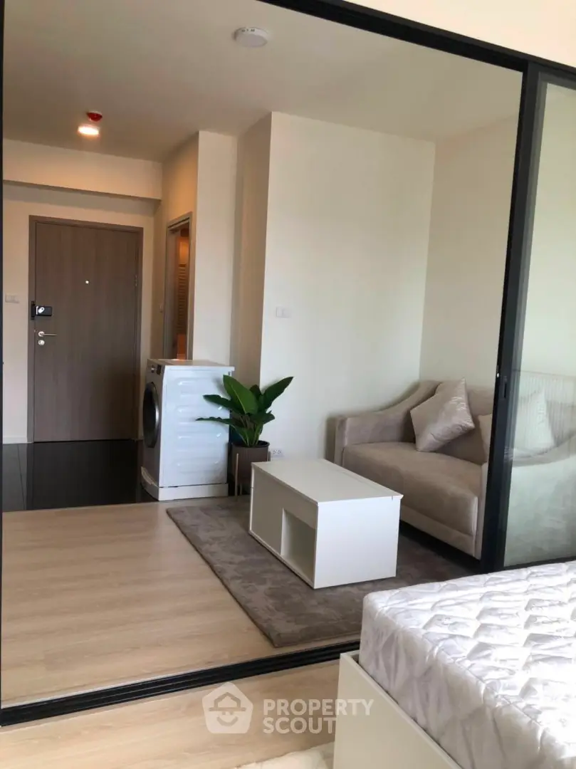 Modern apartment interior with cozy living area and washing machine