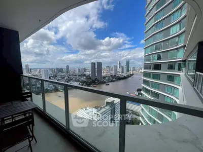Stunning high-rise balcony view overlooking river and city skyline