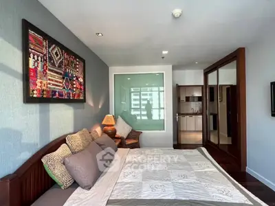 Spacious bedroom with modern decor and ample natural light in a stylish apartment.