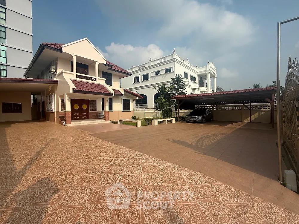 Spacious villa with large driveway and carport in a serene neighborhood