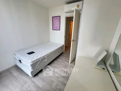 Modern minimalist bedroom with single bed and stylish wall art