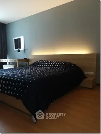 Modern bedroom with stylish lighting and wooden flooring