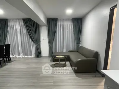 Modern living room with sleek furniture and elegant curtains