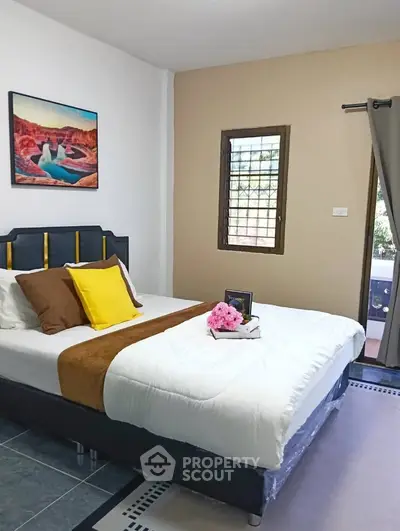 Cozy bedroom with stylish decor and natural light, perfect for relaxation and comfort.