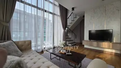 Luxurious modern living room with high ceilings and large windows, featuring elegant decor and a cozy atmosphere.