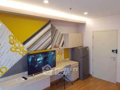 Modern living room with stylish decor, flat-screen TV, and sleek furniture in a contemporary apartment.