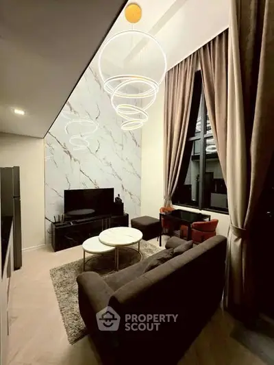 Luxurious modern living room with high ceilings, elegant lighting, and stylish furniture in a contemporary apartment.