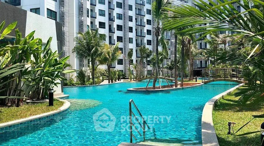 Luxurious apartment complex with stunning pool and lush greenery