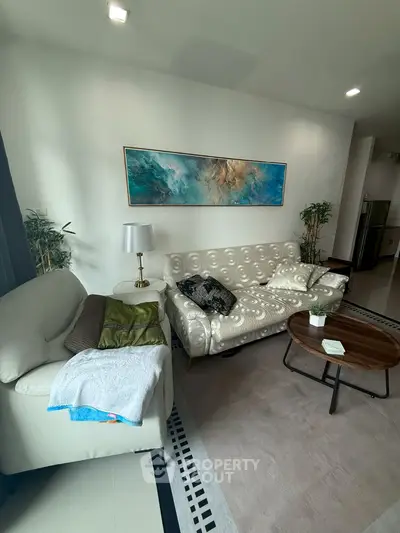 Stylish living room with modern furniture and abstract art on the wall.