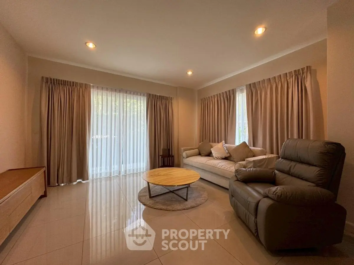 Spacious living room with modern furniture and large windows for natural light.