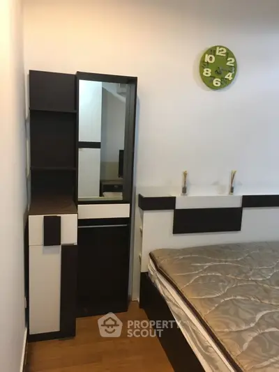 Modern bedroom with stylish furniture and unique wall clock