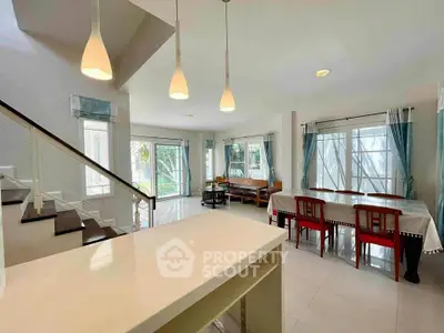 Spacious modern living room with elegant dining area and staircase