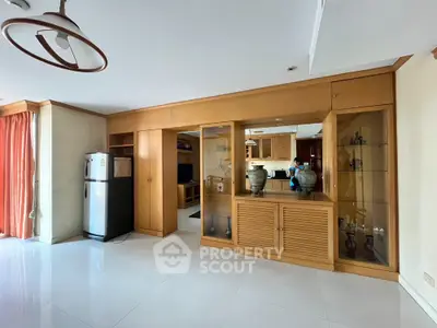 Spacious living room with elegant wooden cabinetry and modern appliances