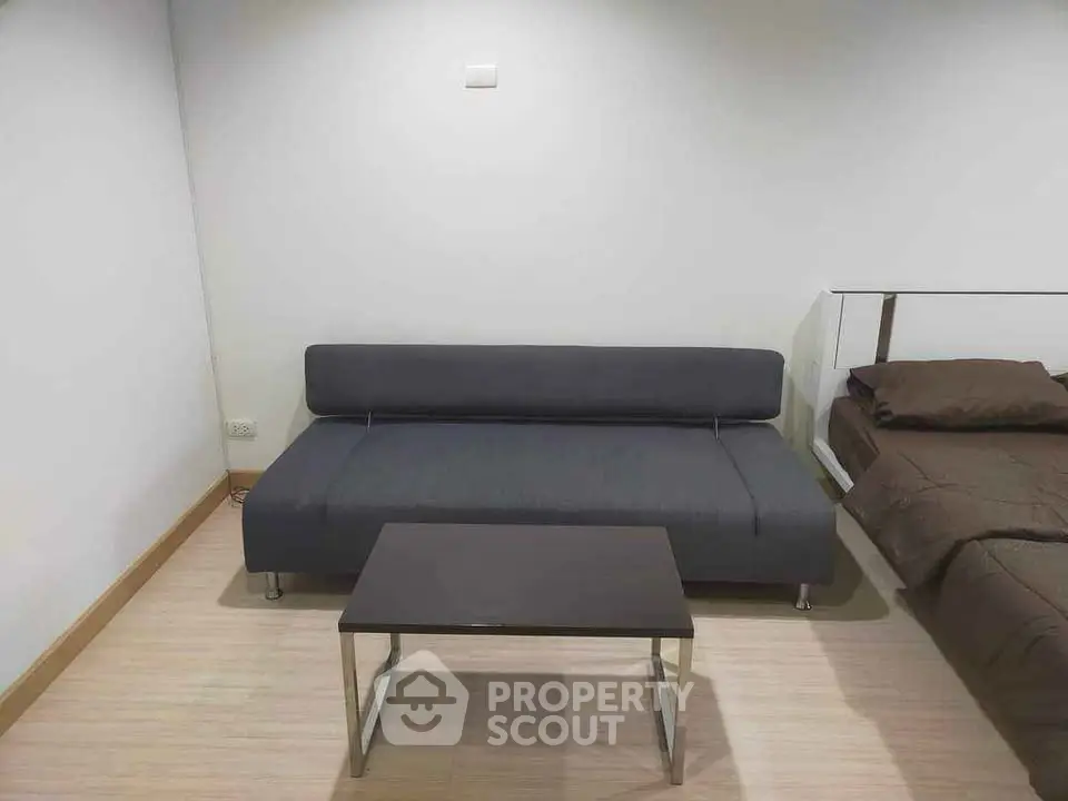 Modern minimalist living room with sleek sofa and coffee table, perfect for urban living.