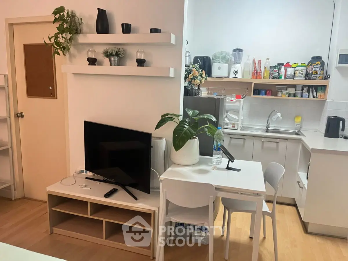 Cozy kitchen and dining area with modern decor and ample storage space.
