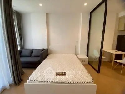Modern bedroom with cozy sofa and minimalist decor