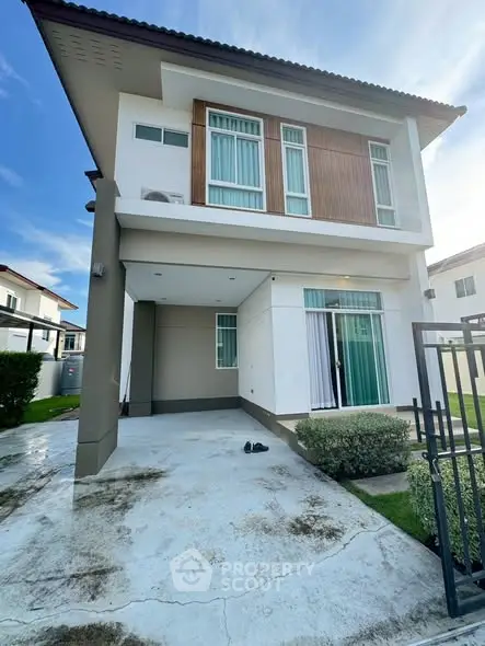 Modern two-story house with sleek design and spacious driveway