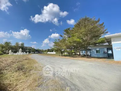 Expansive property with clear blue skies and lush greenery, ideal for development or investment opportunities.
