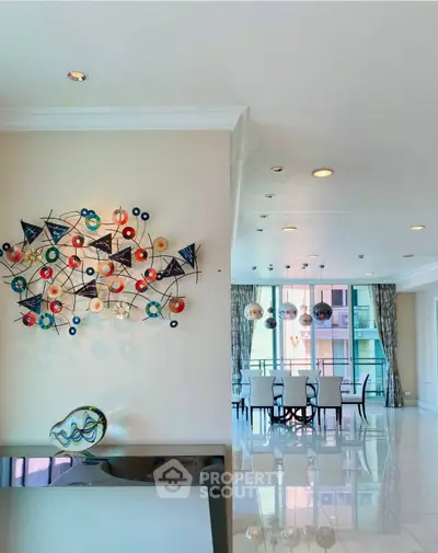 Elegant dining area with modern art and large windows in luxury apartment