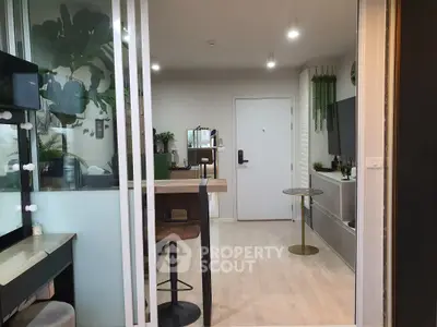 Modern living room with stylish decor and open layout, featuring a cozy dining area and sleek furniture.