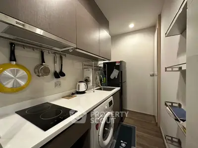 Modern compact kitchen with sleek appliances and efficient storage solutions.