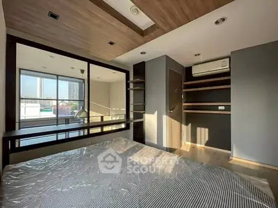 Modern bedroom with large windows and built-in shelves, featuring a sleek air conditioning unit.