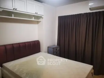 Cozy bedroom with built-in storage and air conditioning in modern apartment.