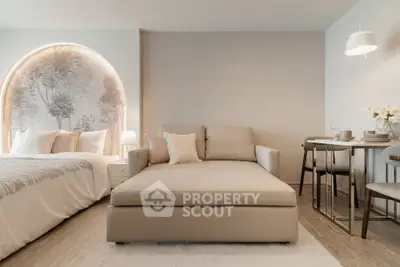 Modern studio apartment with stylish decor, featuring a cozy bed, elegant sofa, and chic dining area.